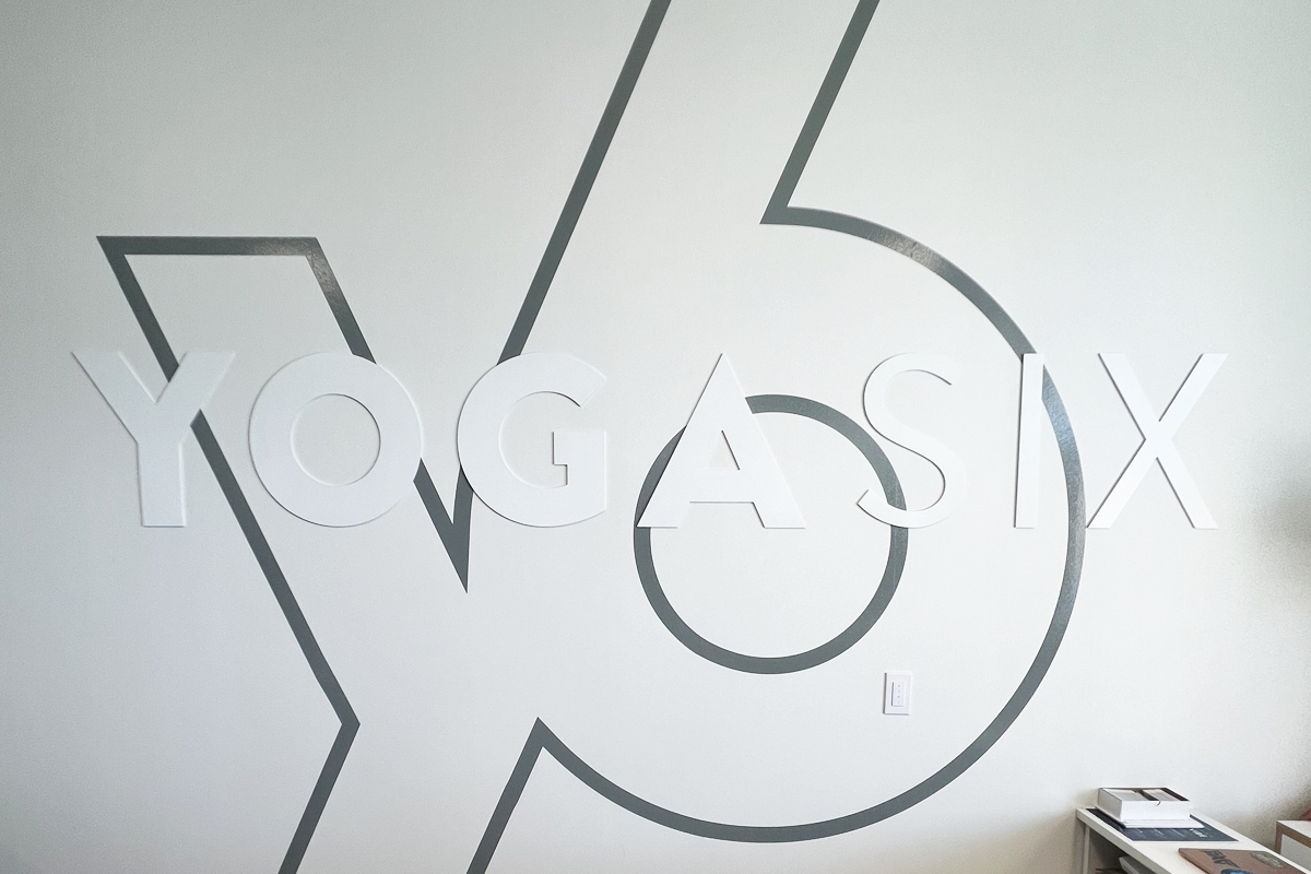 Custom acrylic dimensional letters for YogaSix indoor wall signage in Denver, showcasing durable and modern branding materials.